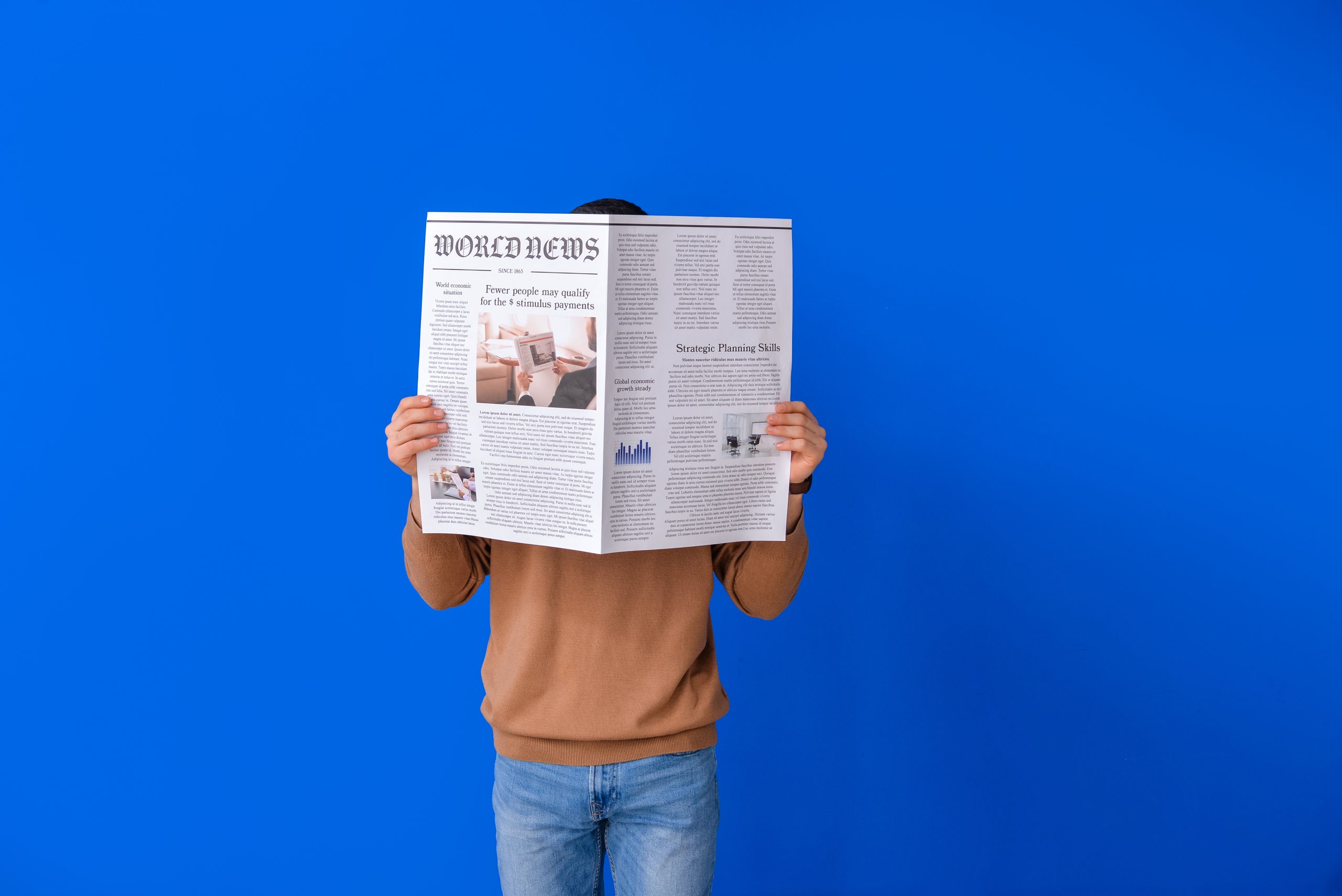 Young man reading newspaper on color background